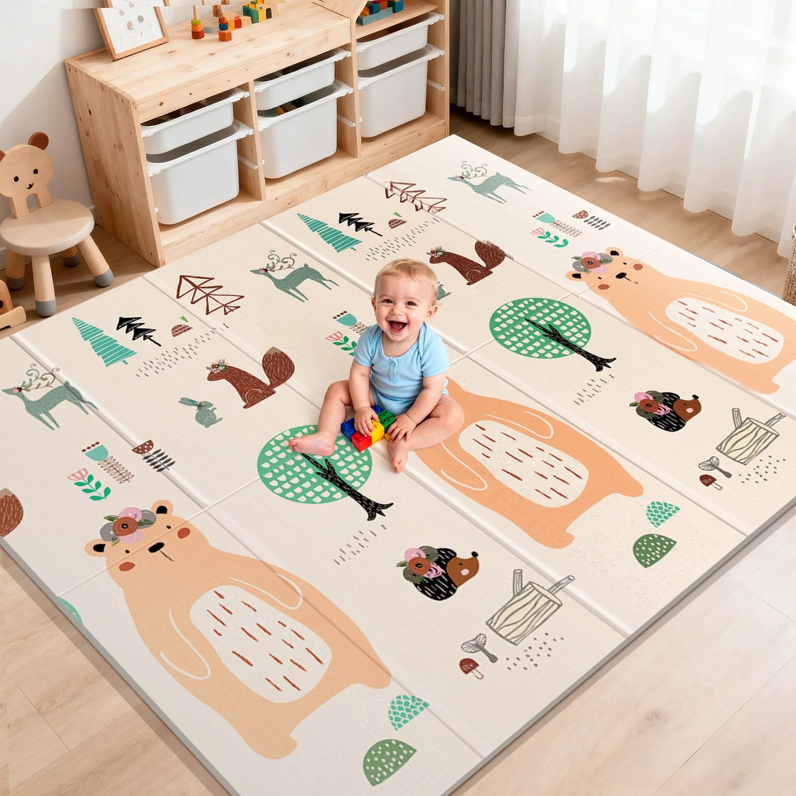 A large foldable play mat open on a wooden floor